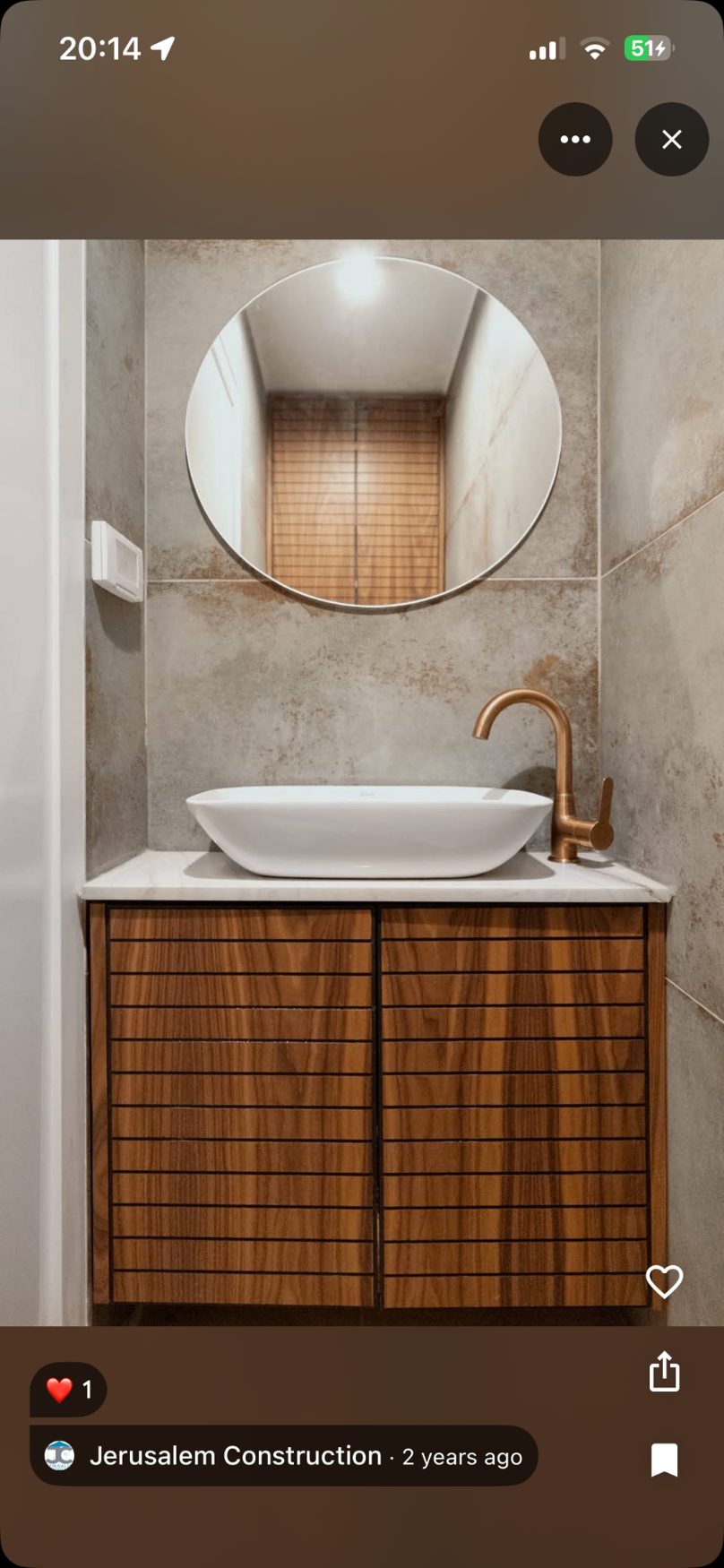 Wooden vanity with vessel sink and round mirror