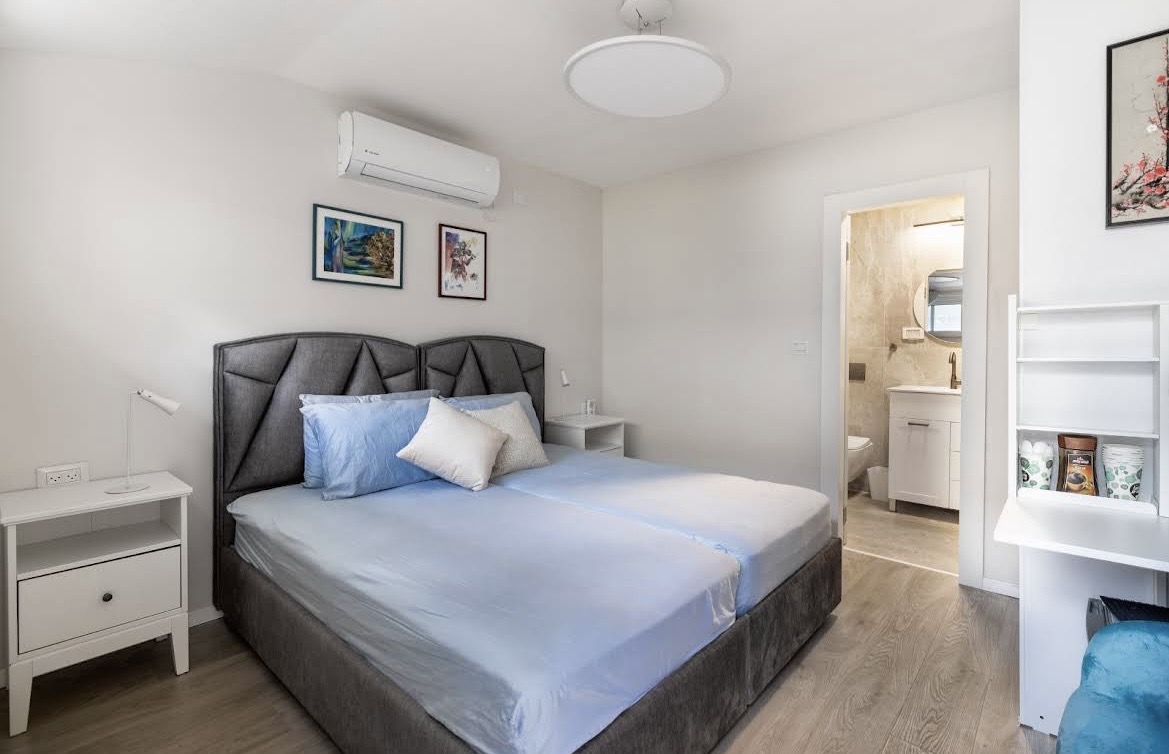 Newly added bedroom with wood floors and en-suite bathroom